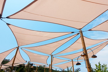 Sun shade sails with sky background.